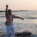 Young man dancing on the coast