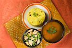 High angle view of pulao in a plate with bowl of curries