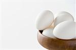 Close-up of eggs in a wooden bowl