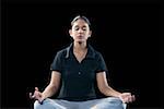 Young woman meditating in a lotus position