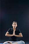 Young woman meditating in a prayer position