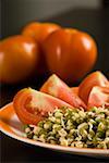 Close-up of a plate of bean sprout with slices of tomato