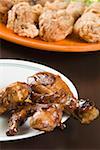 Close-up of fried chicken drumsticks in a plate