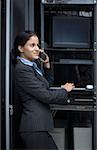 Side profile of a businesswoman talking on a mobile in a server room