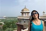 Close-up of a young woman smiling Taj Mahal, Agra, Uttar Pradesh, India