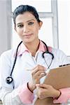 Portrait of a female doctor holding a clipboard