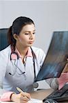 Close-up of a female doctor examining an X-Ray