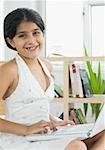 Portrait of a girl using a laptop and smiling