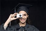 Portrait of a young female graduate taking a picture