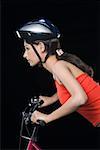 Side profile of a female cyclist riding a bicycle