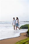 Young couple walking together on the beach