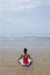 Rear view of a young woman meditating