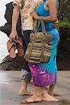 Low section view of a couple embracing each other on the beach