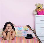 Portrait of a girl lying on the bed and smiling