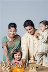 Couple decorating a pooja thali with their children