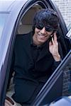 Teenage boy talking on a mobile phone in a car