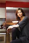 Woman Eating Breakfast in Kitchen