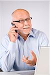 Man with Cellular Phone and Laptop Computer