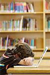 Student in Library, Resting Head on Laptop Computer