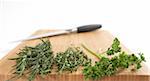 Rosemary, Thyme and Parsley on Cutting Board with Knife