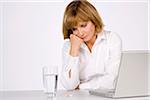 Woman with Glass of Water, Pills and Laptop Computer