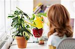 Woman Watering Potted Plant