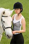 a female horsemanship athlete and her horse