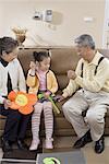 an old couple and their granddaughter,playing a finger- guessing game