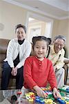 an old couple playing with their granddaughter