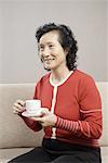 a middle-aged woman taking coffee