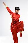 a woman in red dress practicing Chinese Kungfu