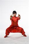 a woman in red dress practicing Chinese Kungfu