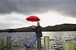 Homme sur les quais en pluie, Windermere, Cumbria, Angleterre
