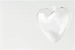 Glass heart ornament filled with snow, close-up
