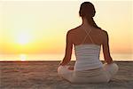 Woman Meditating on the Beach