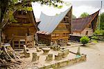 Stone Chairs and Table by Traditional Buildings, Lake Toba, Sumatra, Indonesia