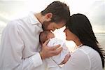 Portrait of Parents With Newborn Baby on the Beach