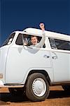 A young man driving a camper van