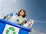Boy carrying box of recycling