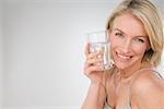 A woman holding a glass of water