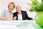 Women laughing, looking at papers