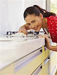 Young woman cleaning kitchen surface