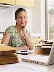 Woman running business at  kitchen table