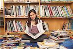 Girl reading a book on the floor