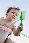 Boy Playing in Sand at Beach