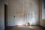 Various Brooms in Empty Room