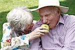 Senior couple with an apple