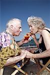 Senior couple with cocktail on beach