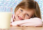 Girl (4-5 years) with a glass of milk