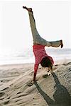 Girl Doing Cartwheel, Huntington Beach, California, USA